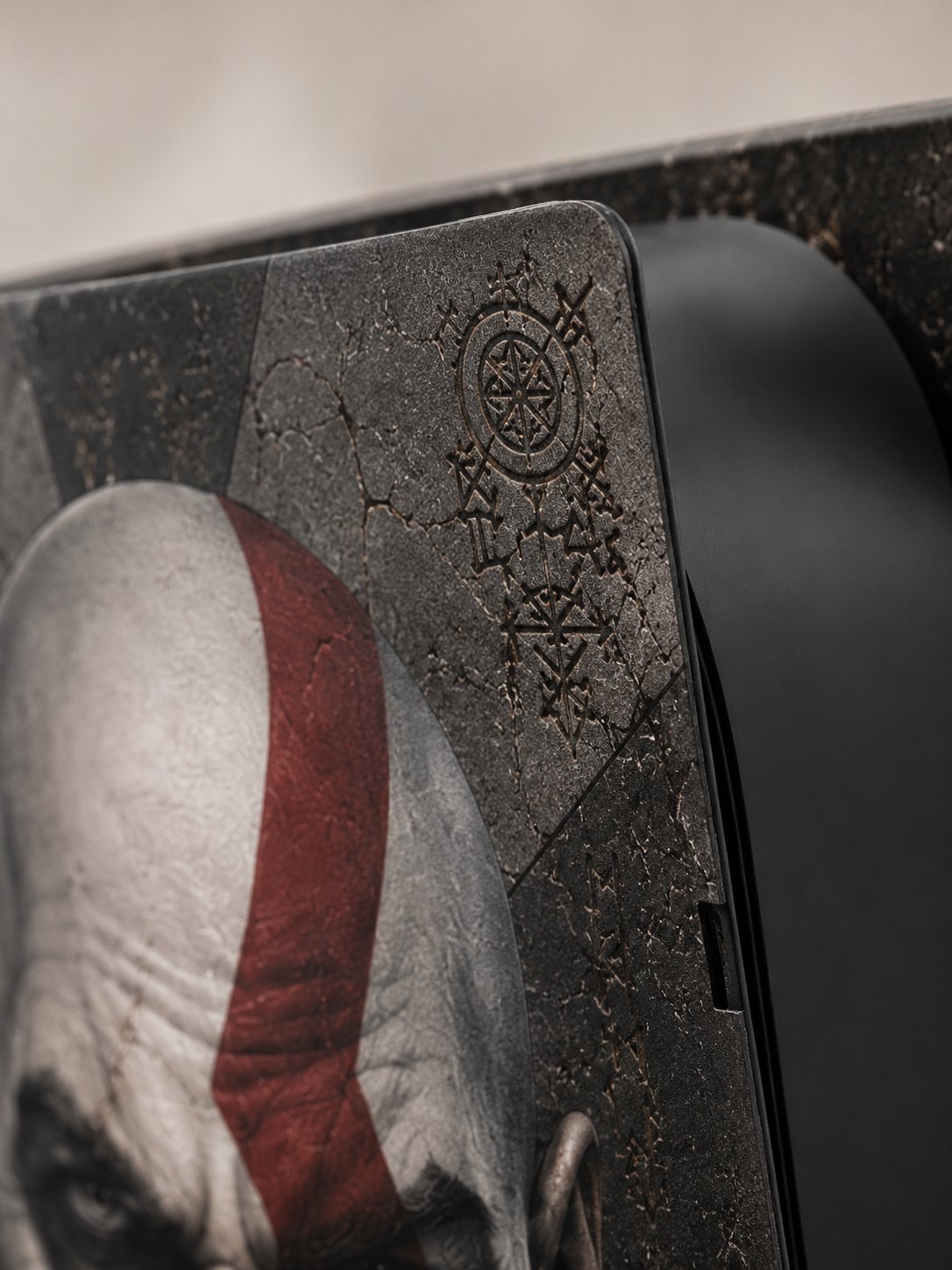Macro close-up of the engraved rune and compass detail showing the cast vinyl finish