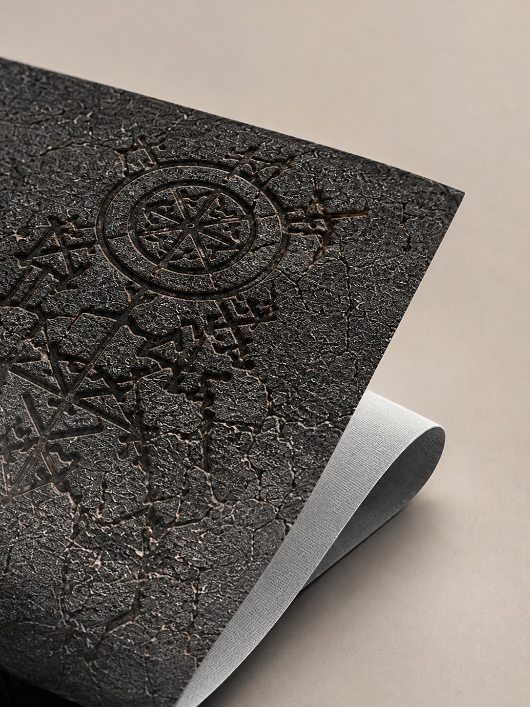 Macro close-up of the engraved rune and compass detail on the Ragnarok skin's cast vinyl surface